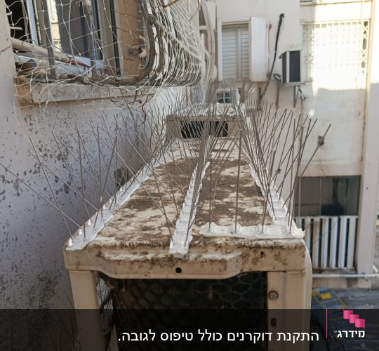דוקרנים ורשת על מזגן למניעת יונים